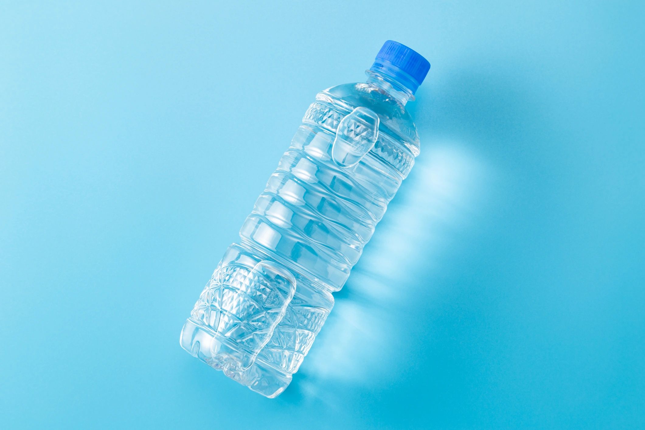 Premium bottled water against a fresh blue backdrop